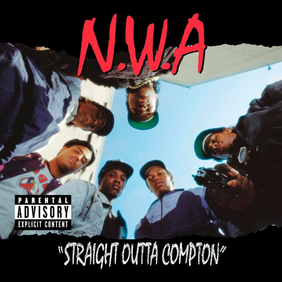 Six young Black men shot from the ground looking up, so they appear to be standing over you. They are arranged in a circle. One of them is pointing a gun at the camera. They all look a little disappointed, like you fucked up and now they have to kill you. Also, please note there is no period after "A" in N.W.A