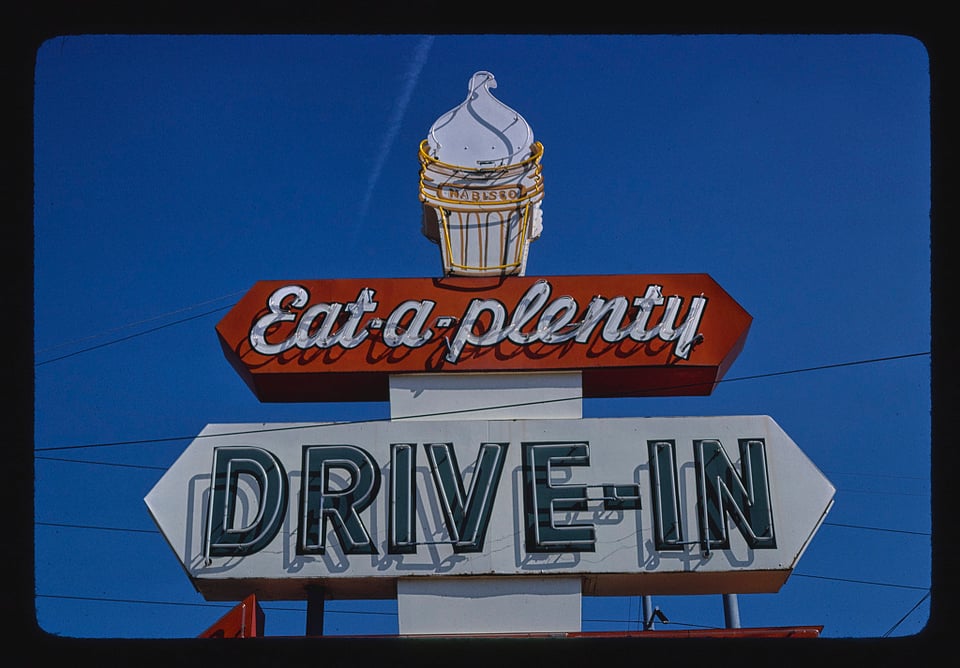 An illuminated sign for an American fast food drive-in ... eat-a-plenty