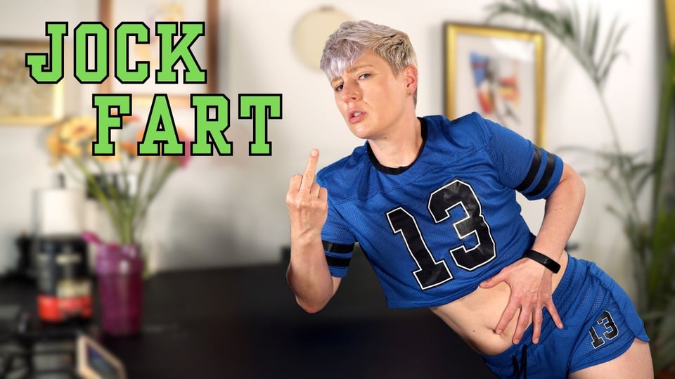 Cover image for "Jock Fart," which shows Jaq wearing a crop-top athletic outfit and dramatically clutching their belly with one hand and flipping off the viewer with the other.