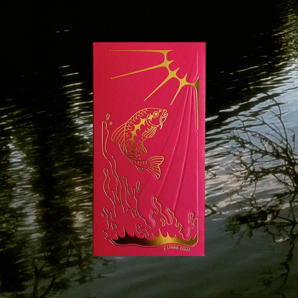 a red envelope with gold foil design of a carp jumping up an embossed waterfall