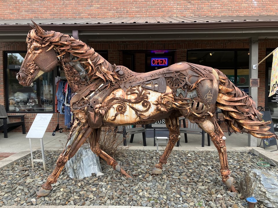 Metal horse sculpture in Hill City, South Dakota, which incorporates tiny metal figures.