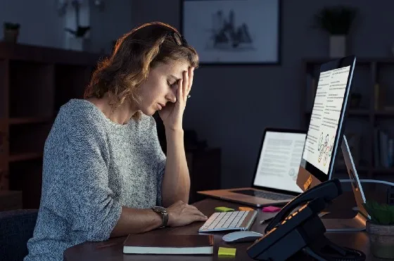 a woman sitting at a desk at night