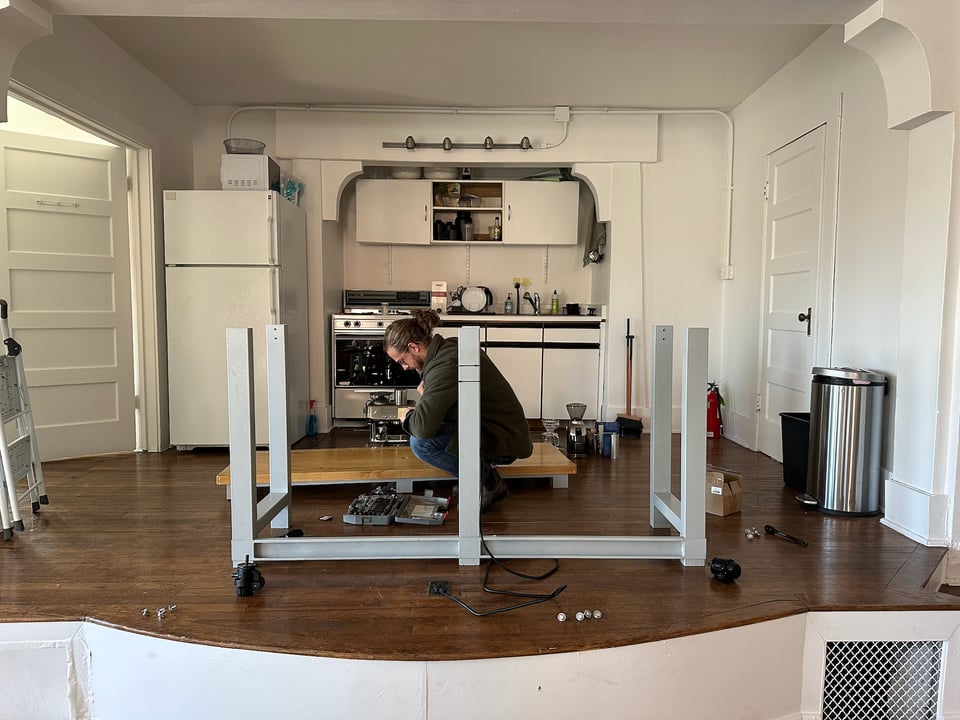 Jim installing casters on a table.