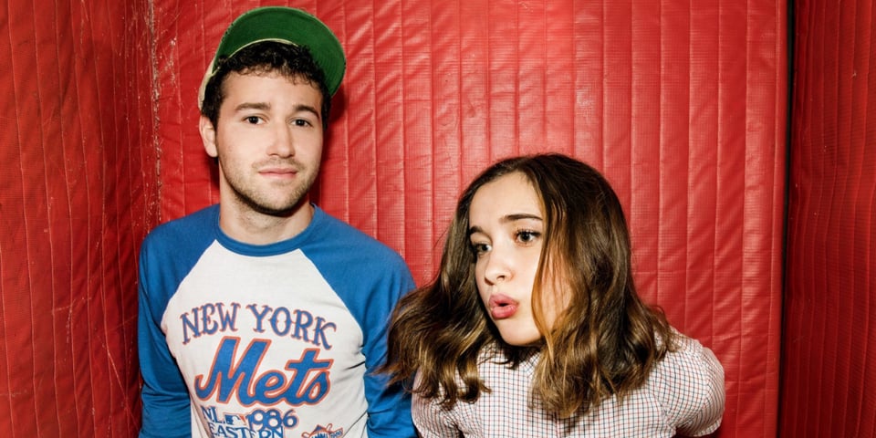 Clyde and Gracie from Lawrence in a red room.