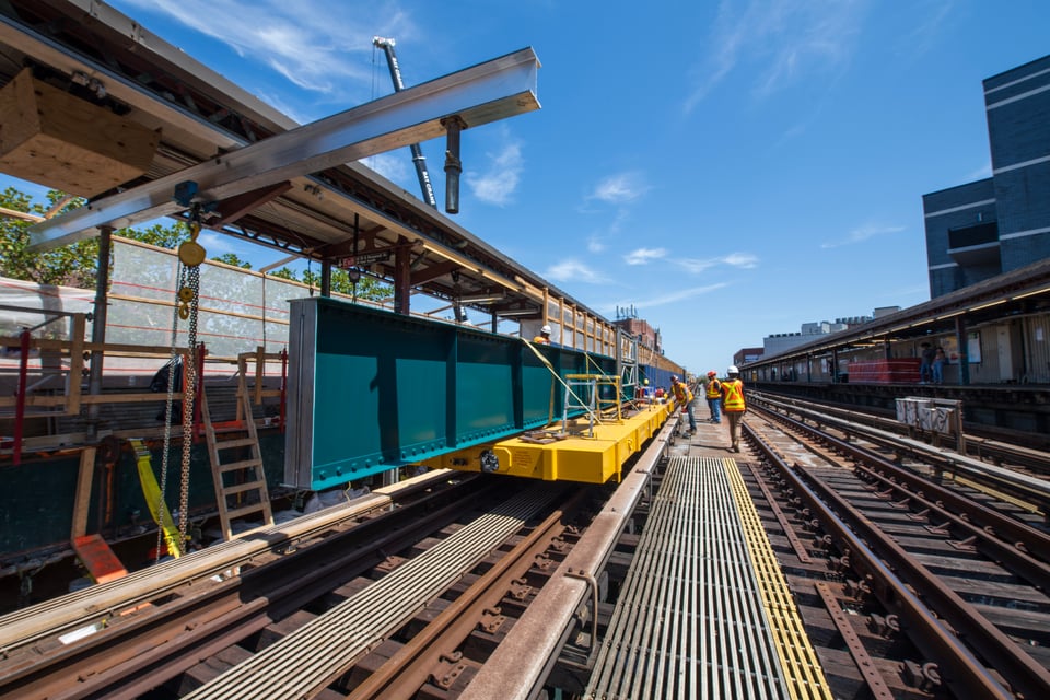 MTA construction crew members with a girder swing, adding new girders along the tracks of the aboveground 7 train.