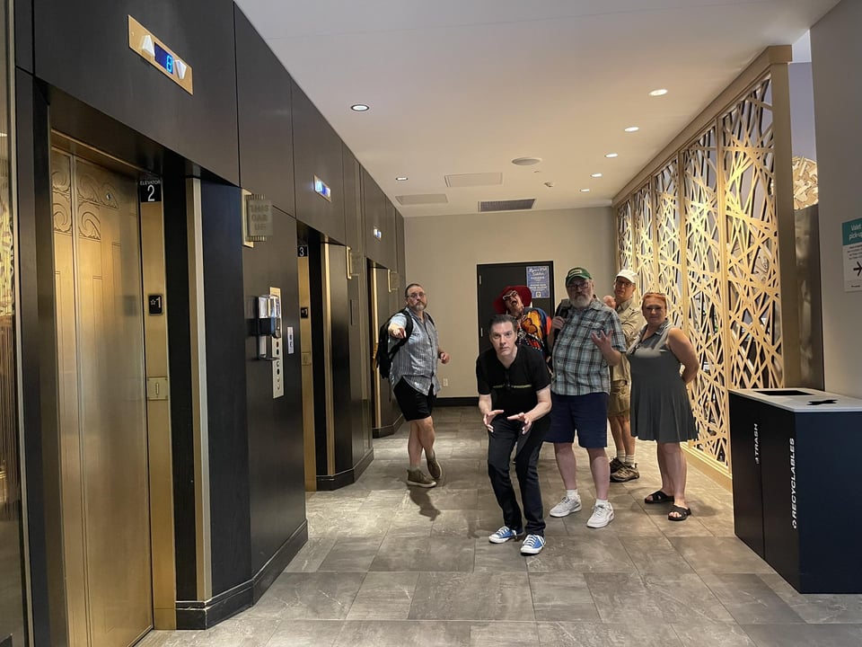 A group of people in a hallway, displaying various levels of donut fever