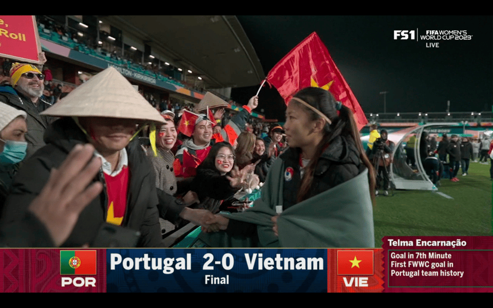 Vietnam fans crowding to the front of stands to greet and cheer for the Vietnamese players after their loss