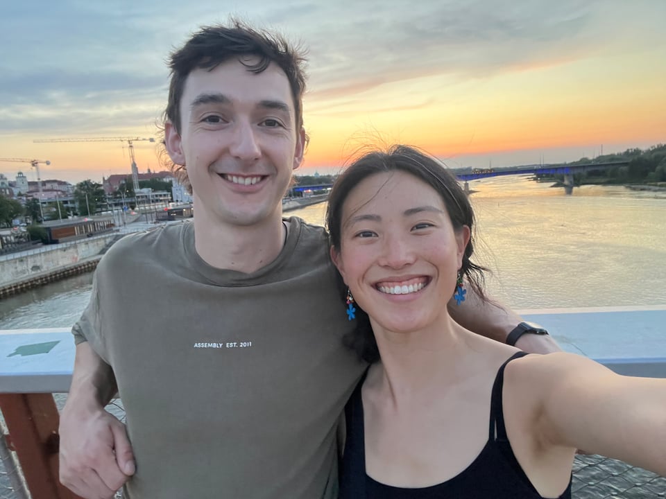 Fergus and Jenny taking a selfie in front of a river at sunset