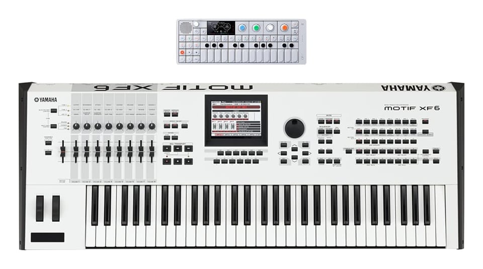 An image of the Teenage Engineering OP-1 instrument next to the much larger Yamaha Motif XF6. The OP-1 is 11.1 inches long while the Motif is 41.25 inches long.