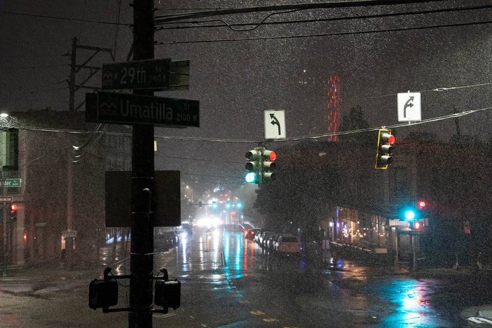 A dark snowy street scene.