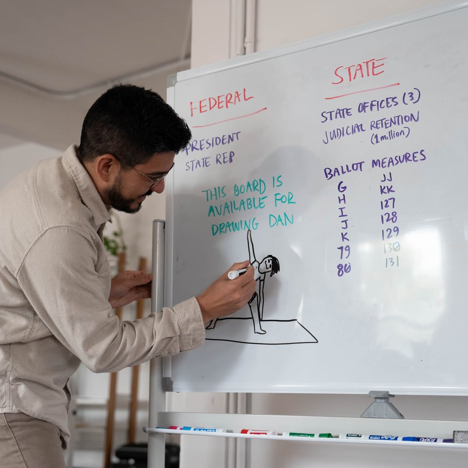 Justin drawing on a whiteboard.