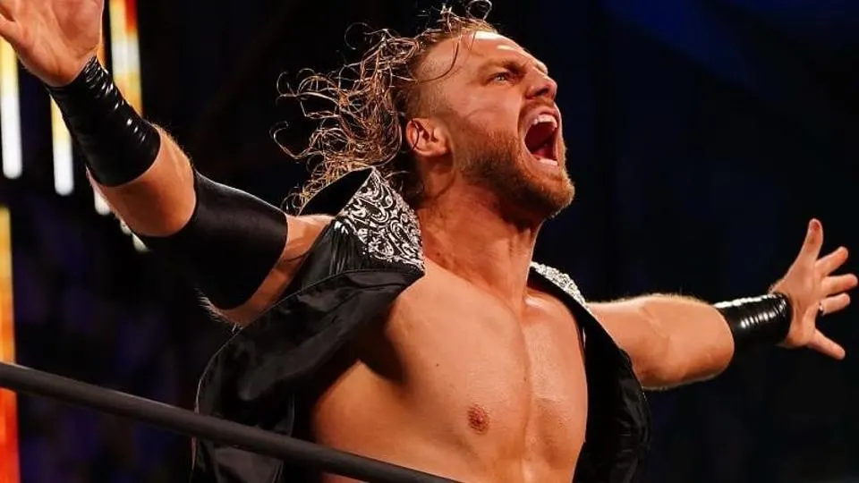 Adam Page, arms spread wide, turning and shouting at the camera during his entrance.