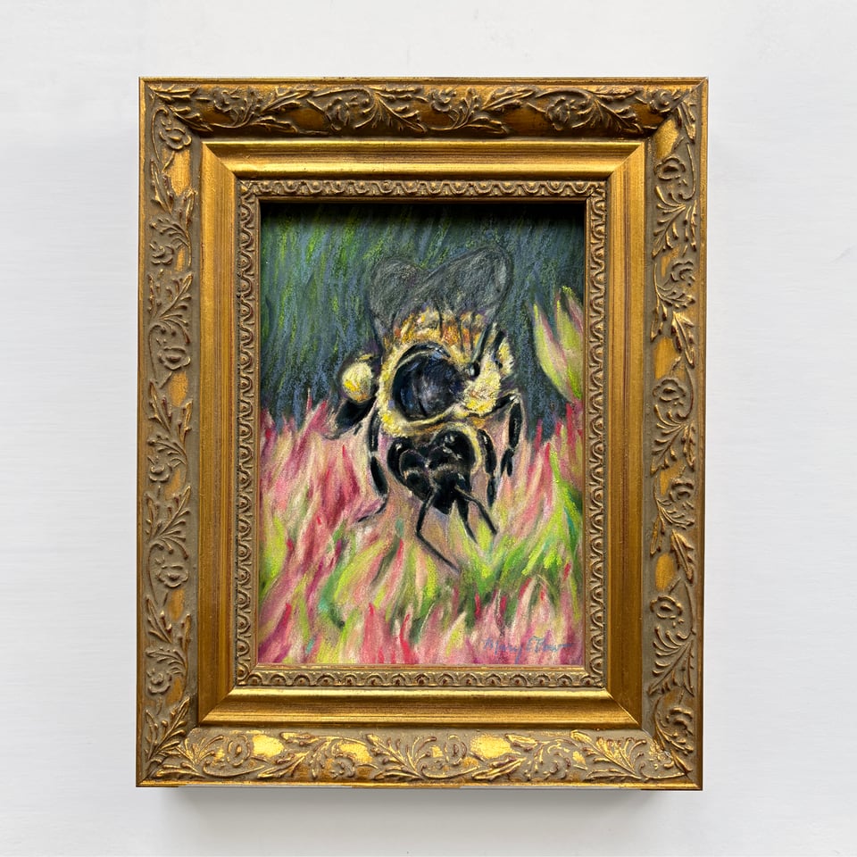 artwork of a honeybee framed in a gold frame