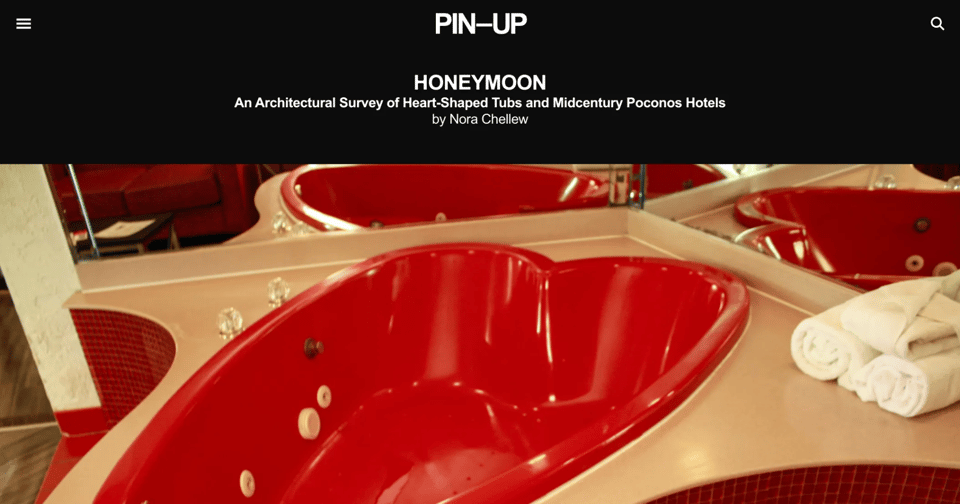 a screengrab of the piece on the PIN-UP website. white type on a black background and a big, nice high res photo of a heartshaped tub in a honeymoon hotel