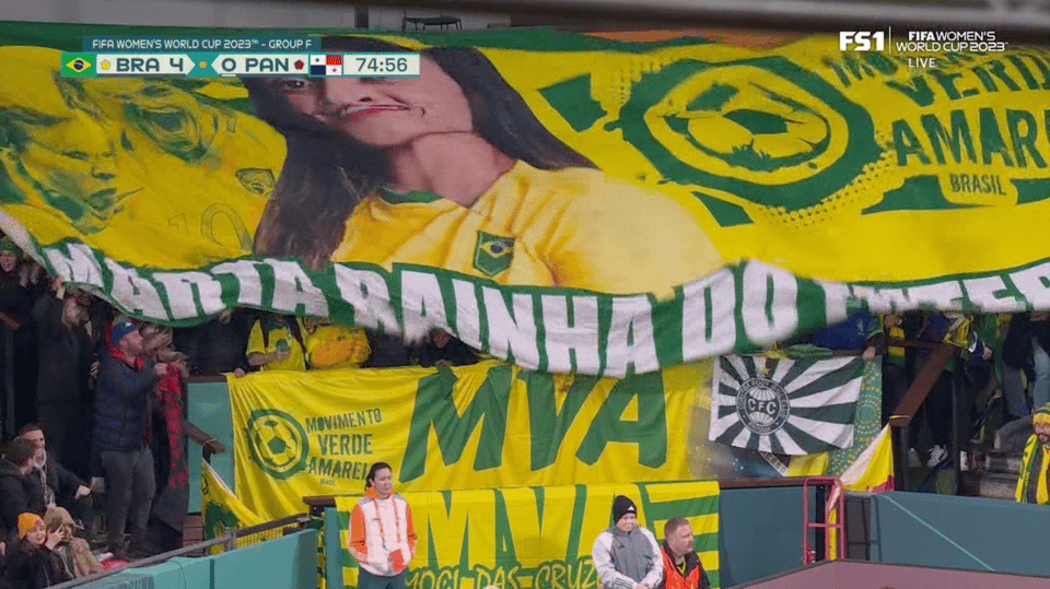 A screenshot of the Brazil-Panama match in the 75th minute. In the stands, fans are unfurling a tifo in Marta's honor