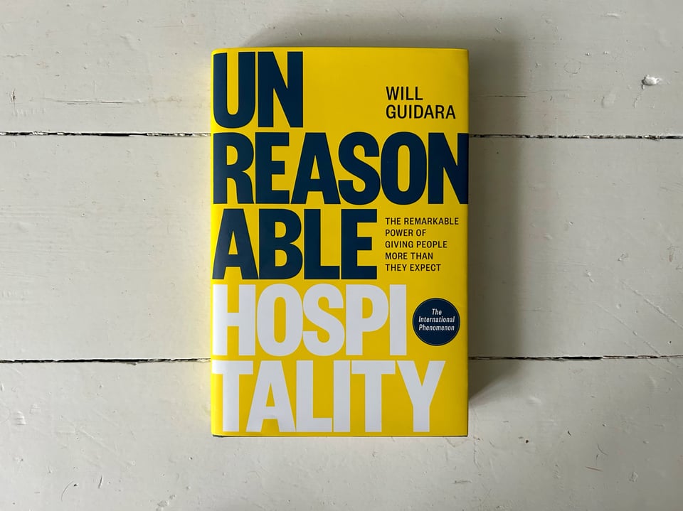 Photograph of the book, "Unreasonable Hospitality" by Will Guidara. The subtitle reads, "The remarkable power of giving people more than they expect."