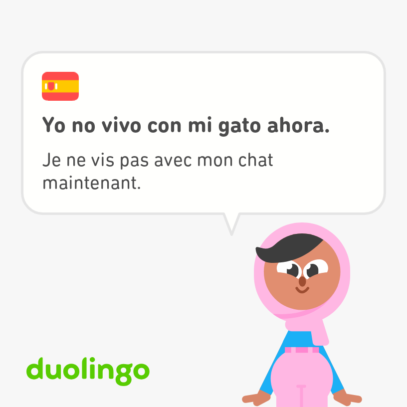 Zari--hijab-wearing teenaged K-pop fan of Duolingo--says, "I don't live with my cat now," in French and Spanish.