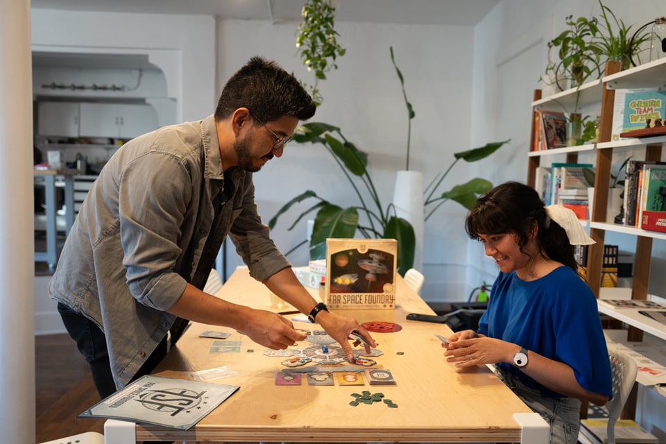 Justin teaching Livvy a board game.