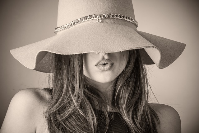 woman wearing hat in grayscale photography