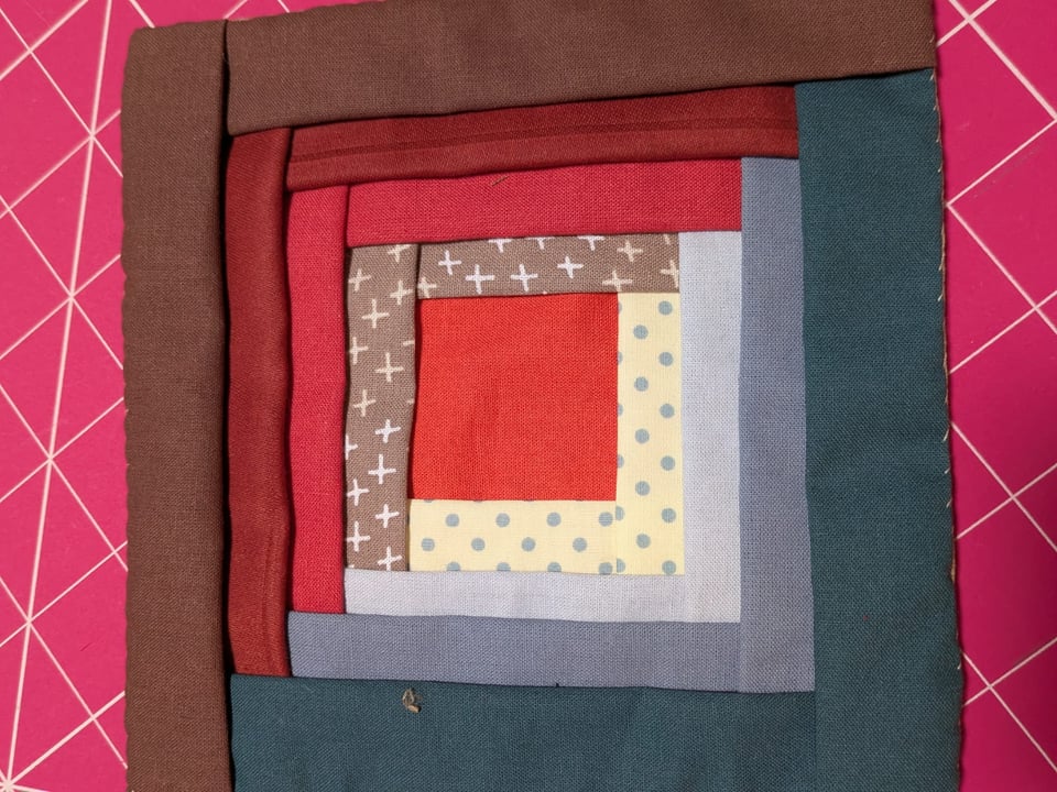 A patchwork quilt square in the Manx tradition: concentric square windows around a central square