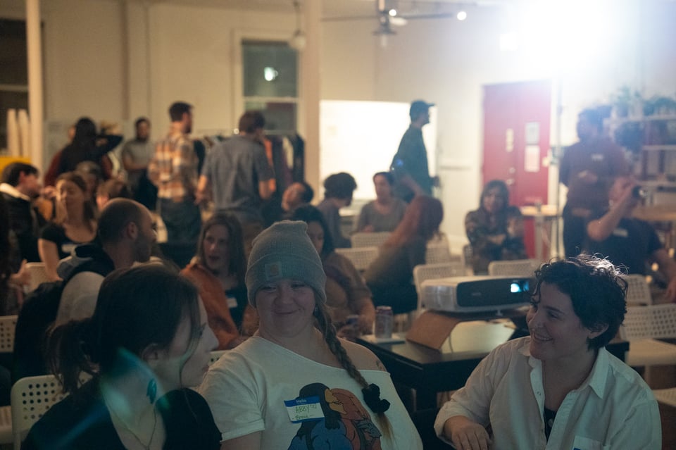 A crowd in a lit room.