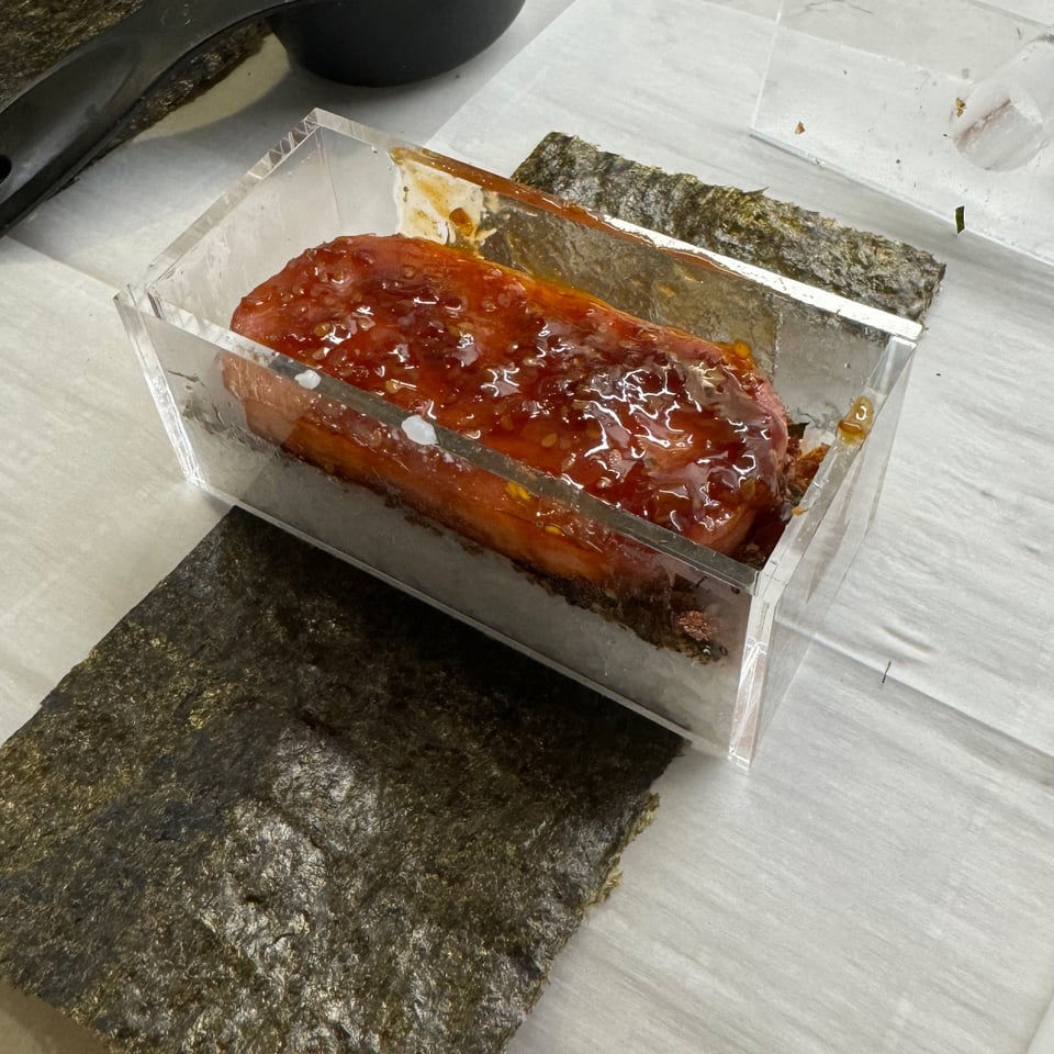 Spam, sauce, and rice on seaweed.