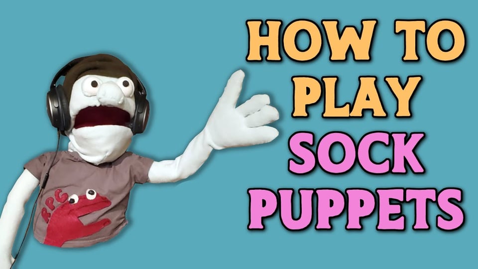 An image of a felt and fleece, vaguely humanoid puppet wearing headphones, hand raised aloft. Text on-screen reads "How to Play Sock Puppets".