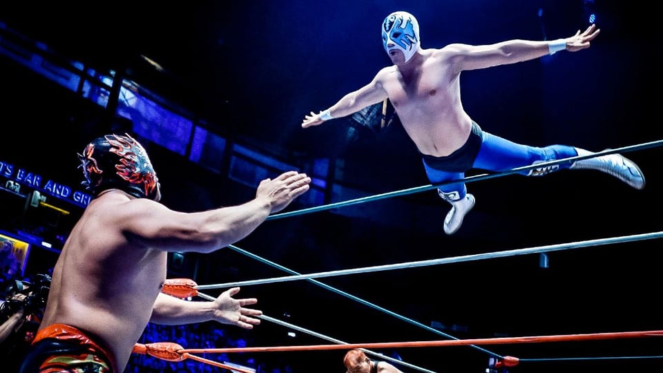 Two Lucha Libre wrestlers fighting in a wrestling ring