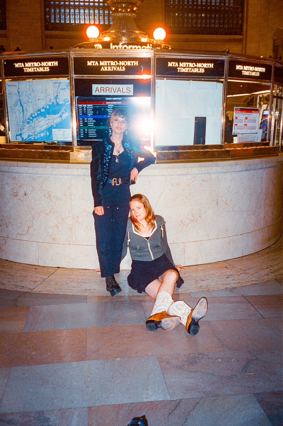 Tallen and Beth pose in front of the ticket counter at Grand Central Station