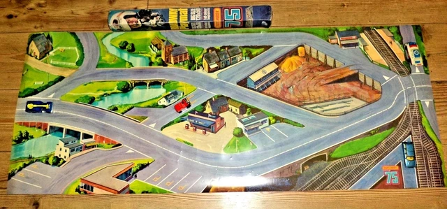 a playmat that shows a series of roads and buildings, forming a country town