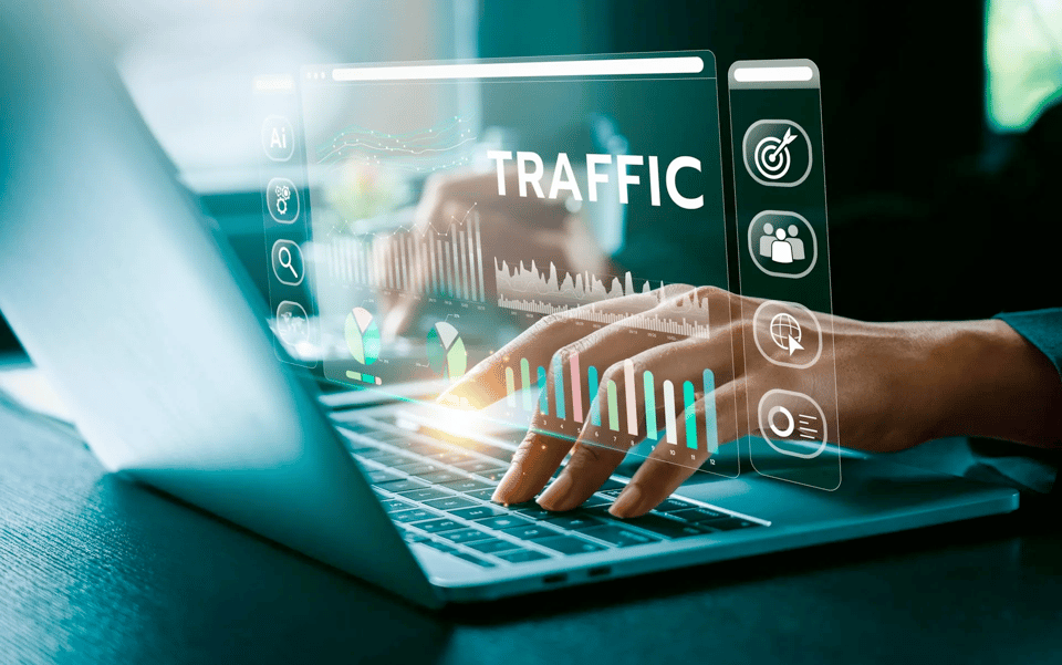 Stock graphic of fingers on a keyboard overlaid by a web traffic display