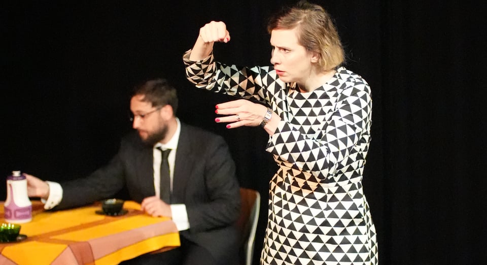 A woman, Katy, and a man, Gael, at a table
