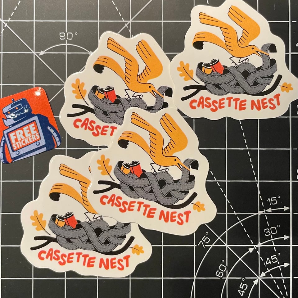 Several stickers with the Cassette Nest bird illustration and a smaller orange sticker on the side that reads “Free Stickers” on the chest of a robot