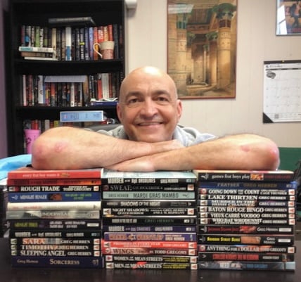 Author Greg Herren and all the books he has written. Trust me, it’s a fucking lot.