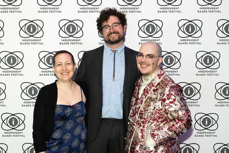 Jess, Matt Carney, and Arden Ripley posing in front of an IGF backdrop