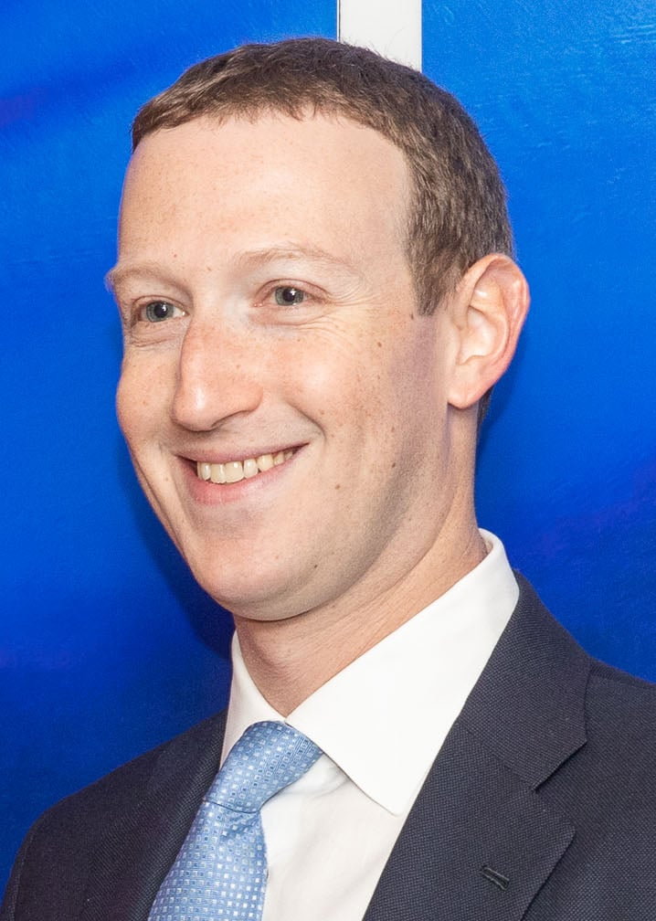 Mark Zuckerberg smiling at something out of frame and to the left. Image via https://en.wikipedia.org/wiki/Mark_Zuckerberg#/media/File:Zuckerberg-Jourov%C3%A1_meeting_(2020)_(cropped).jpg