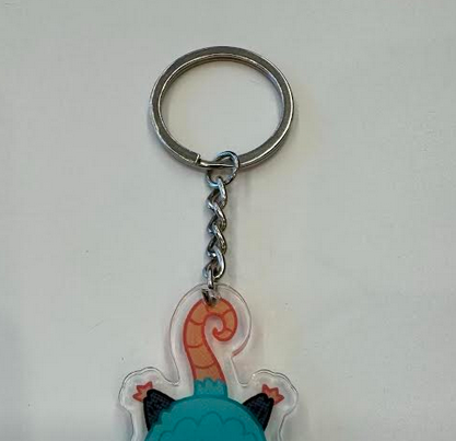 preview of a keychain with a possum hanging on the chain with his tail. Only half of the keychain is shown.