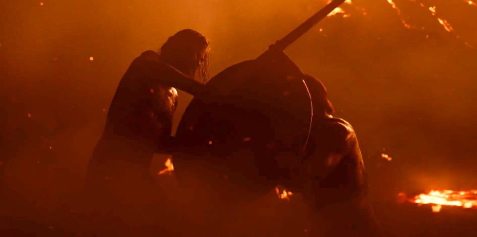 Two men battling in low light in a volcano