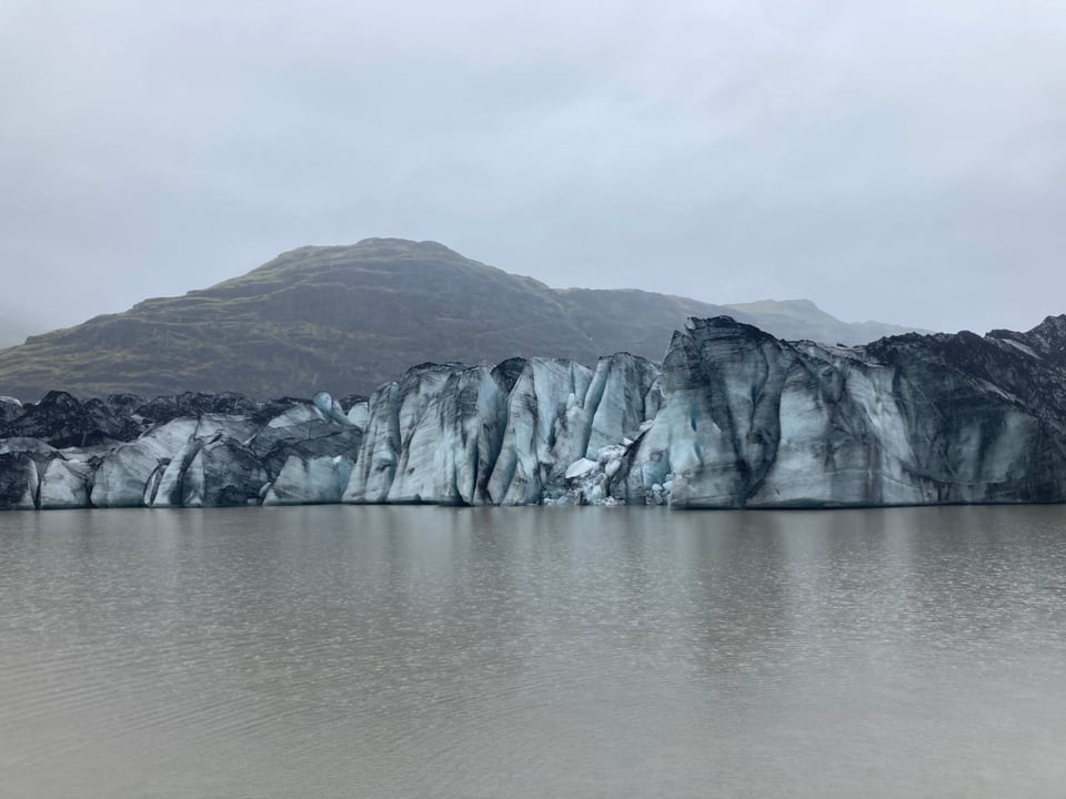 Glacier dotted with volcanic ash