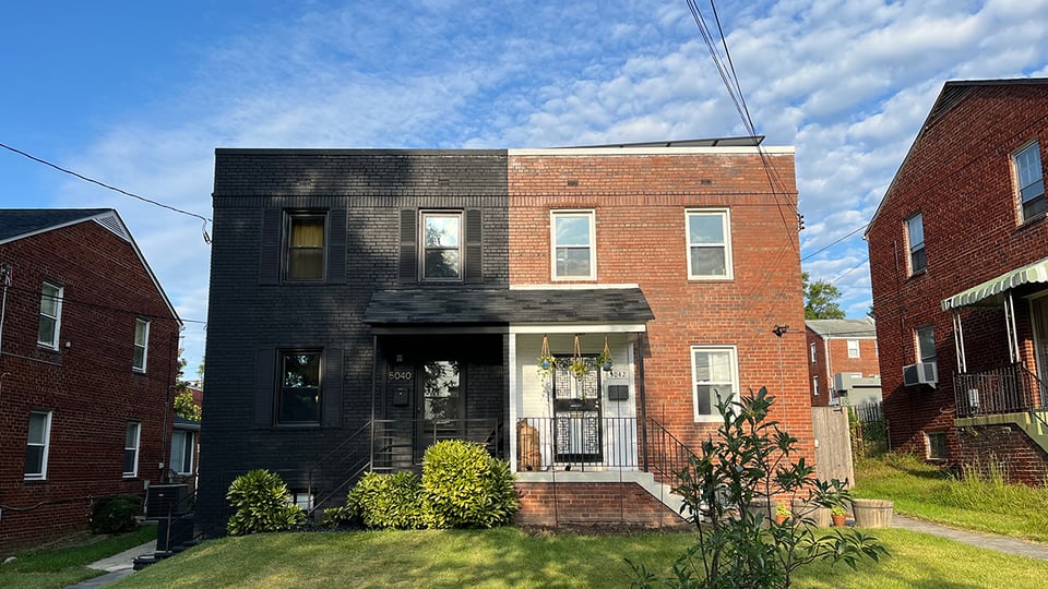 The house painted black on the left really needs to find a buddy in the one next door.