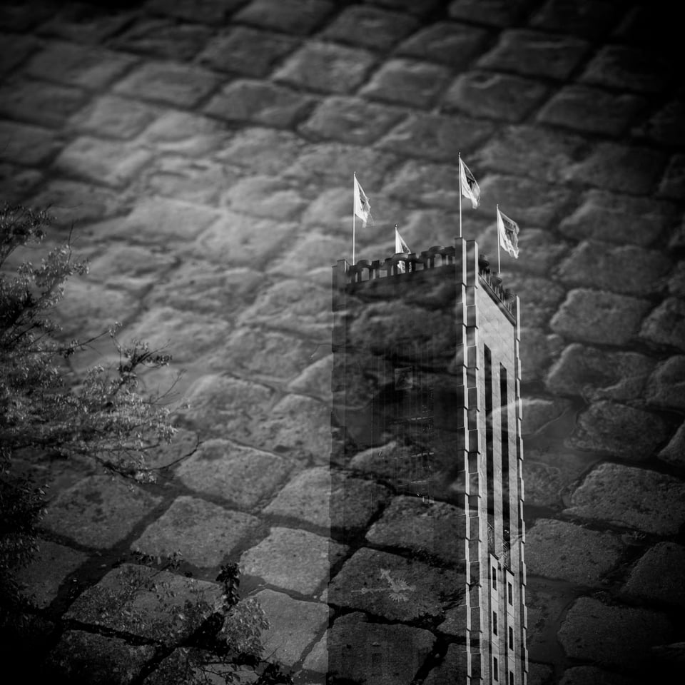 Västerås cityhall tower, doubleexposed with cobblestone.
