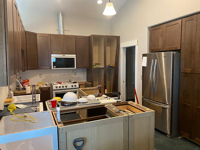 Kitchen cabinets being installed