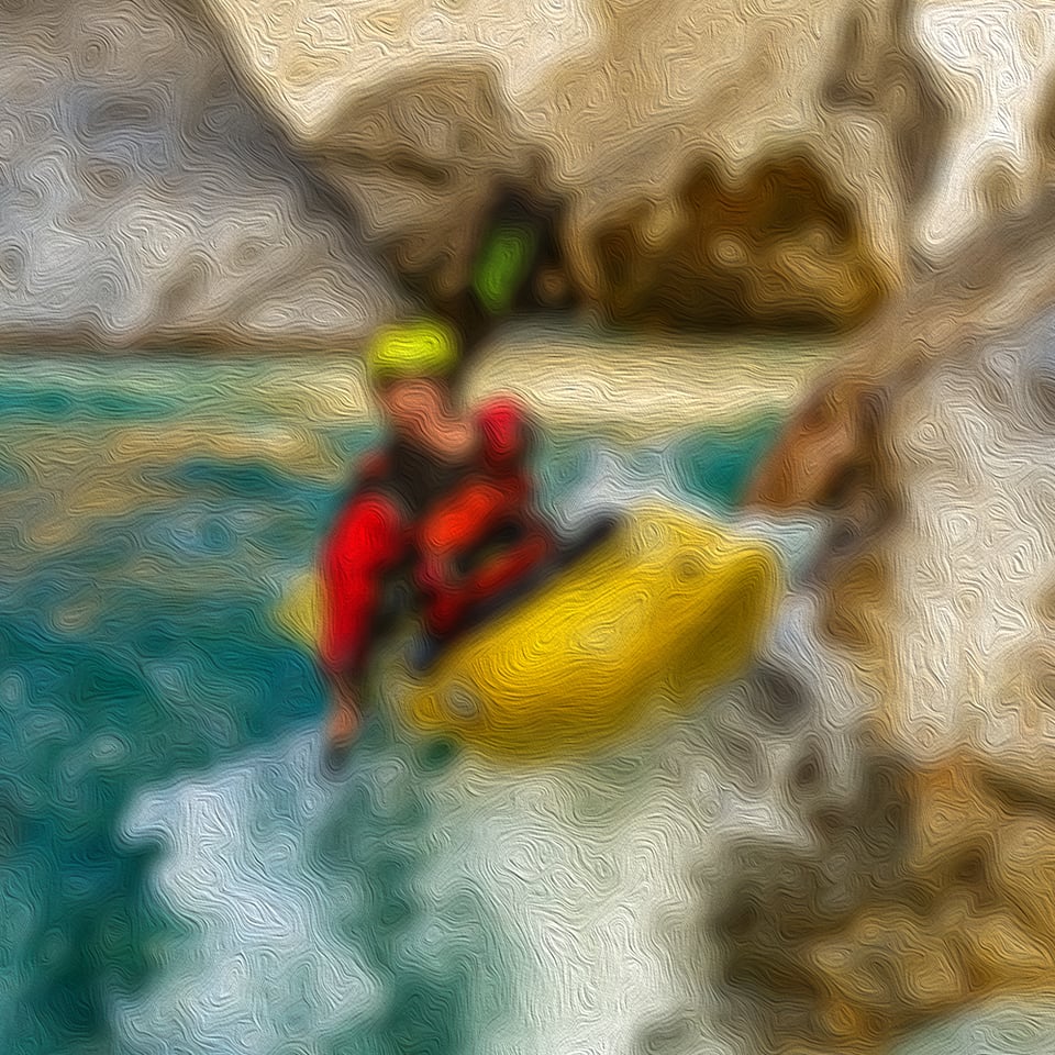 whitewater kayaker leaning toward rock