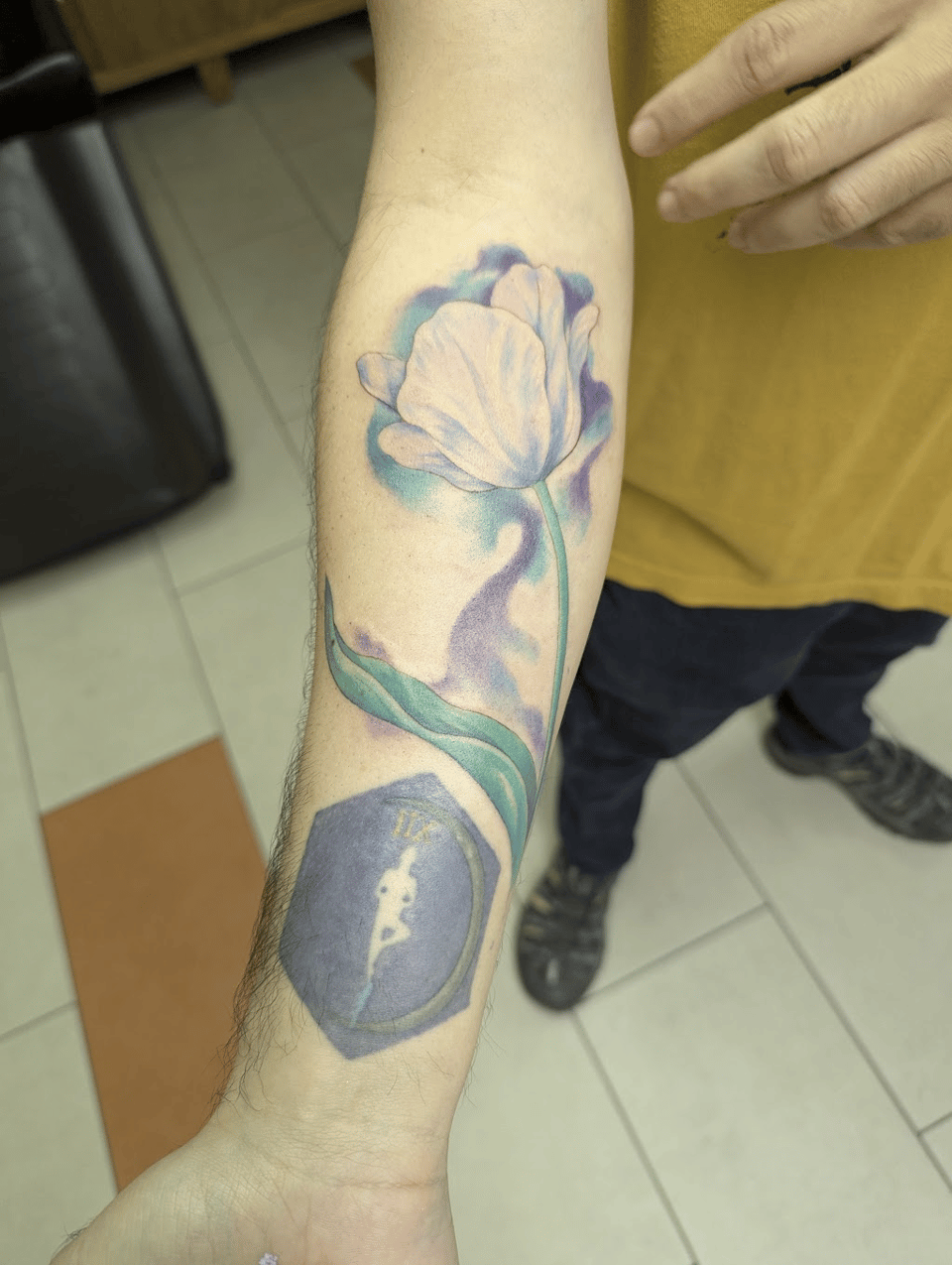 A water color white tulip tattoo.