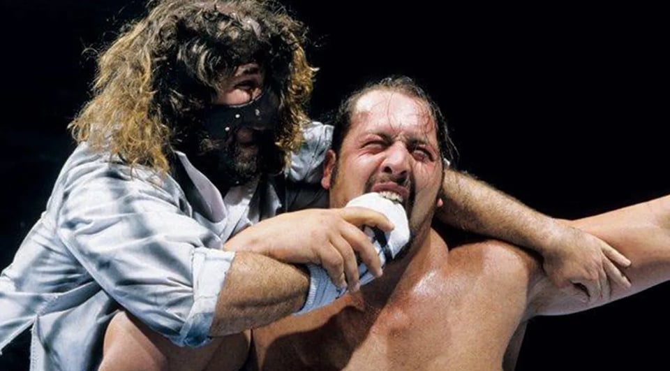 WWE wrestler Mankind delivers his Mandible Claw move to the Big Show.