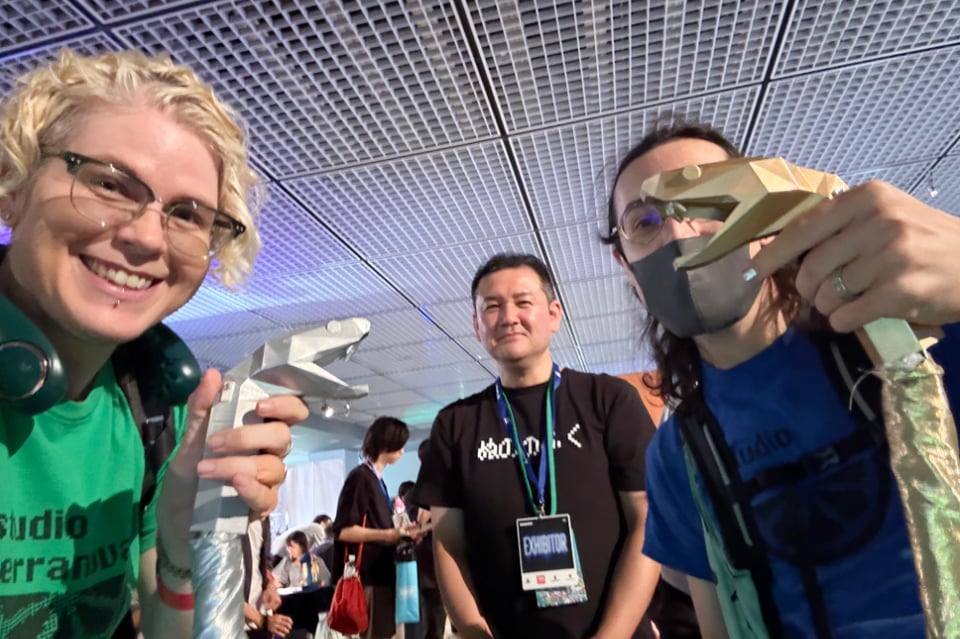 Photo of us holding the “hebi-con” (snake controllers) and the dev, Wataru Nakano.