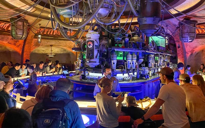 an image of people drinking at the bar in oga's cantina at star wars galaxy's edge in walt disney world