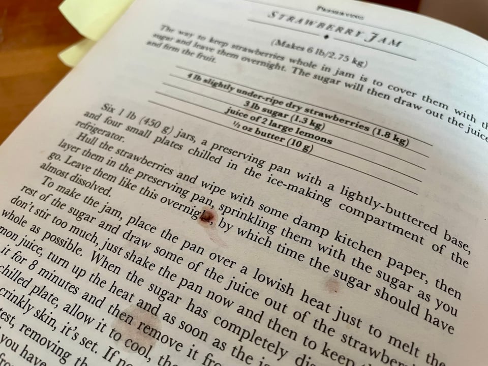 A dot of strawberry jam on a recipe for strawberry jam