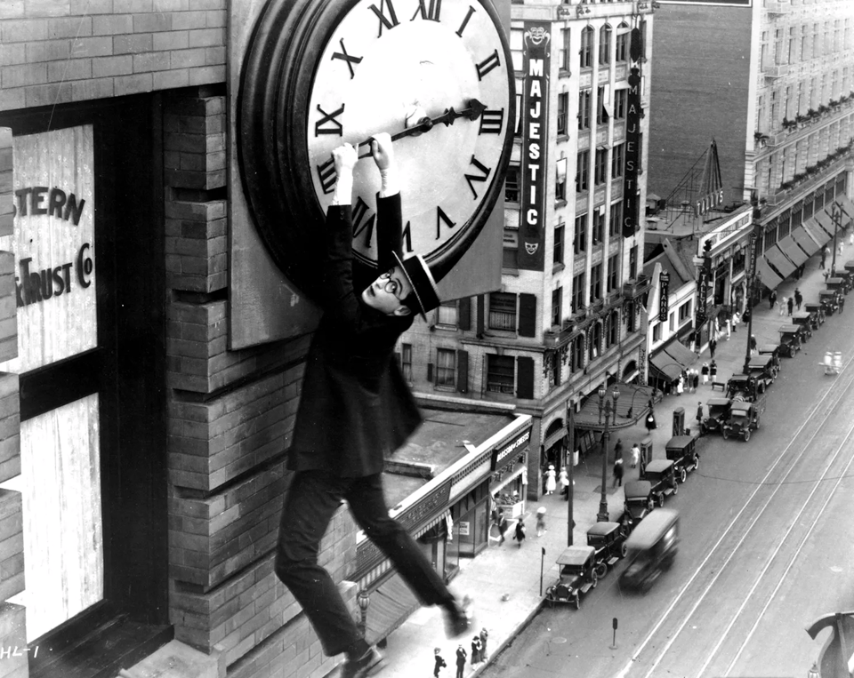 Buster Keaton hanging from a clock in the 1923 film "Safety Last"