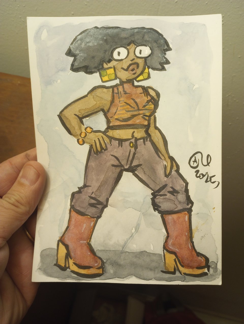 Tina in a sheer top, pants, and boots